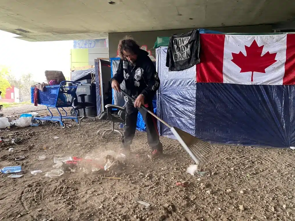 Steve cleans a section of the encampment under Ville-Marie Expressway.
