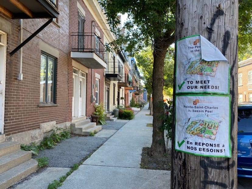 Signs posted in Pointe-Saint-Charles by the community group Action-Gardien about upcoming development in Bridge-Bonaventure.